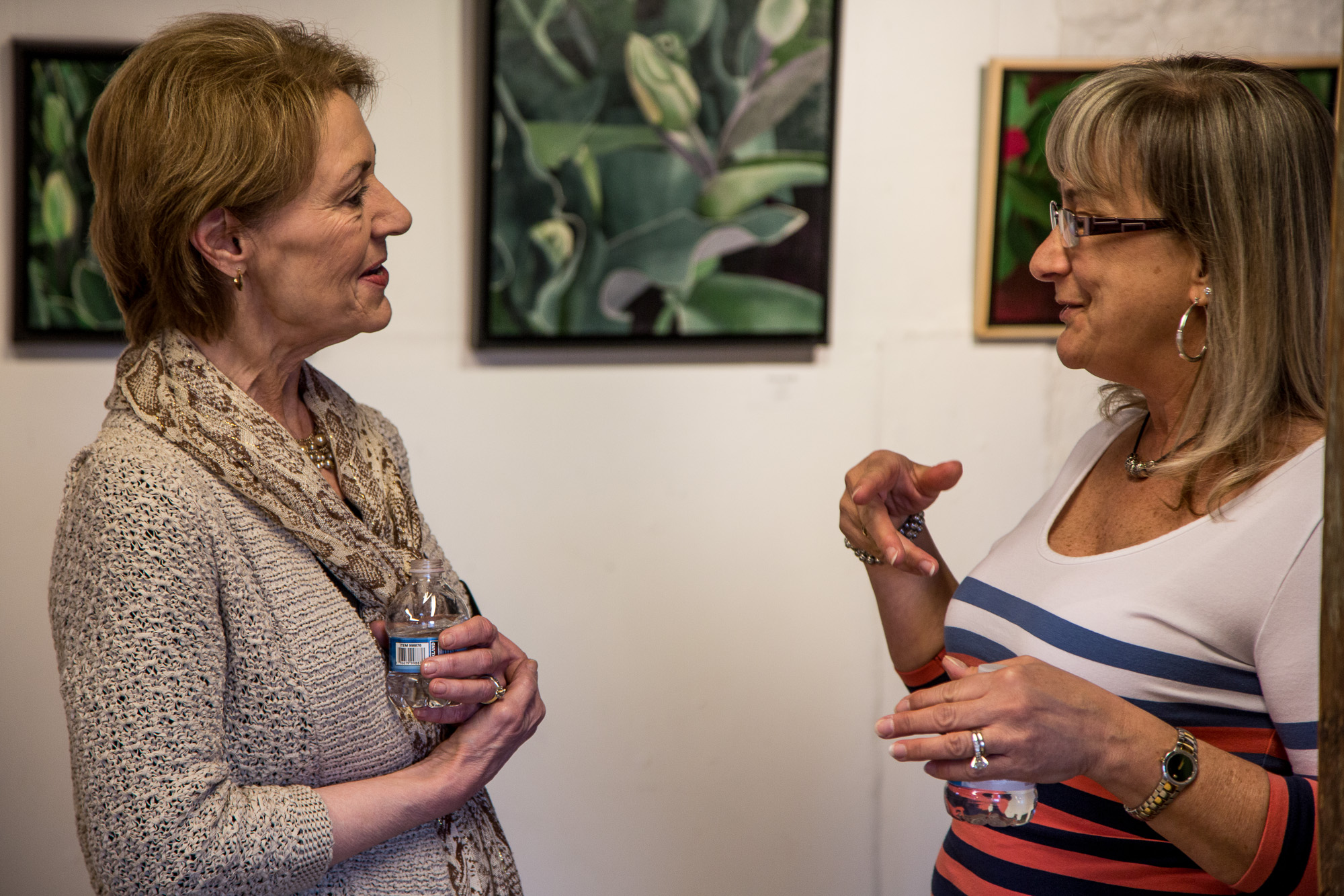 Kathy Guzman with a visitor in her Member's Gallery exhibit