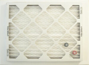 Air Filter Reverse Side with Placed Beer Bottle Caps #2, Decorated air filter on Canvas by John Nichols, 18in x 24in, NFS (October 2021)